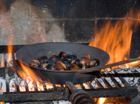 Roasted chestnuts in the fireplace Stock Photos