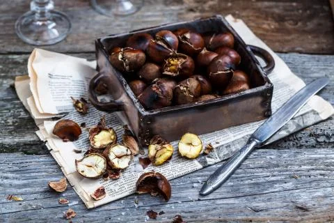 Roasted chestnuts in an old box. Selective focus. Stock Photos