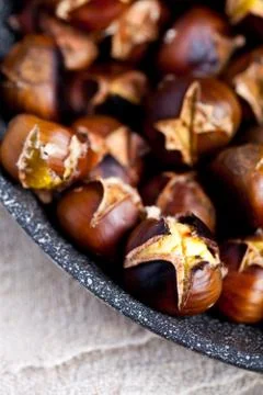 Roasted chestnuts in a pan Stock Photos