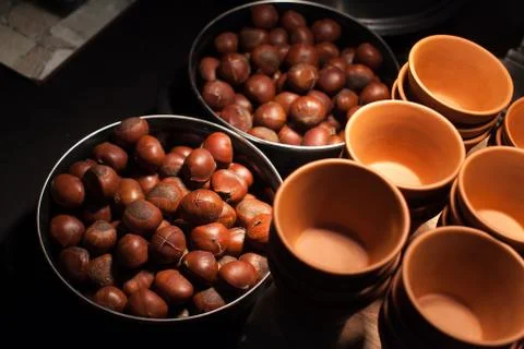 Roasted chestnuts on silver tray put on table in restaurant. Stock Photos