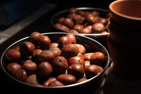 Roasted chestnuts on silver tray put on table in restaurant. Stock Photos