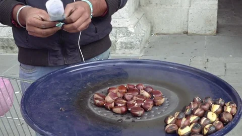 Roasted chestnuts steaming on big blue metal pan Stock Footage 71821569