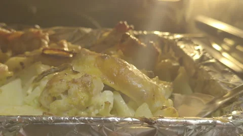 Roasted Chicken and Potatoes in Foil Tray Inside Oven, Hot Steaming Food 库存影片 335338733