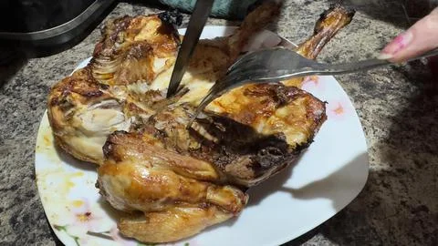 Roasted Chicken Being Sliced with Fork and Knife Stock Photos