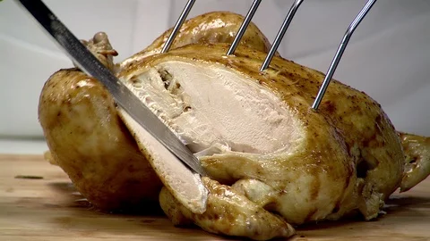Roasted chicken breast being sliced with large carving knife 2 Stock Footage 102136853