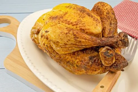 Roasted chicken in a dish on a table   Stock Photos