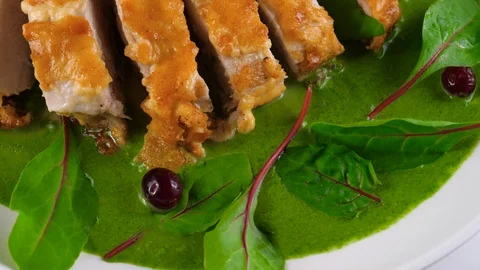 Roasted chicken fillet on creamed spinach sauce, close-up view Stock Footage 87566286
