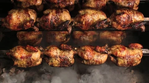 Roasted chicken grilled on fire, barbeque. In South America called "pollo a la b Stock Footage 65200708