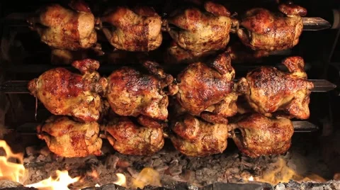 Roasted chicken grilled on fire, barbeque. In South America called "pollo a la b Stock Footage 65200880