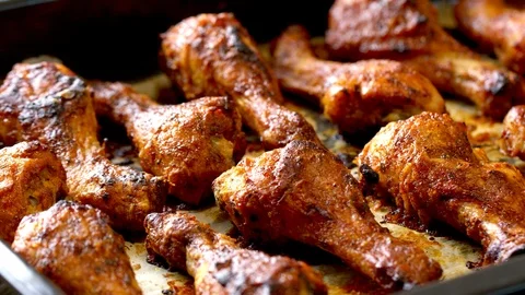 Roasted chicken legs BBQ in baking pan. Video shot 4K 50 fps. Stock Footage 118824322
