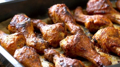 Roasted chicken legs BBQ in baking pan. Video shot 4K 50 fps. Stock Footage 118824324