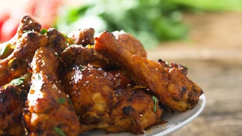Roasted chicken legs BBQ in baking pan decorating with sesame herbs and honey Stock Footage 118824747