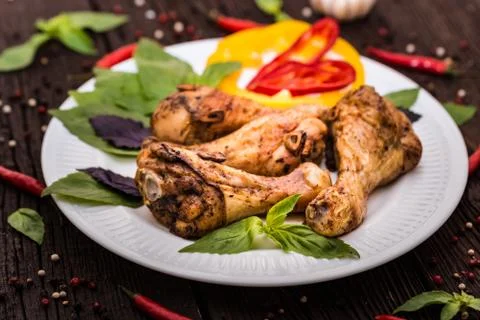 Roasted chicken quarter legs on rustic background Stock-Fotos