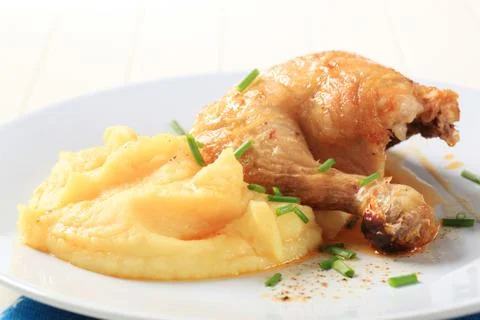 Roasted chicken quarter served with mashed potato Stock Photos