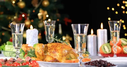 Roasted chicken ready to be served on Christmas festive table with candles Stock Footage 119986979