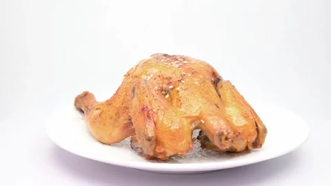 Roasted chicken rotating on white Video stock 345971490