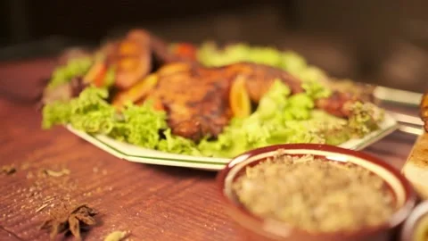 Roasted chicken served with lettuce and bowls of spices and mustard sauce Stock Footage 147232954