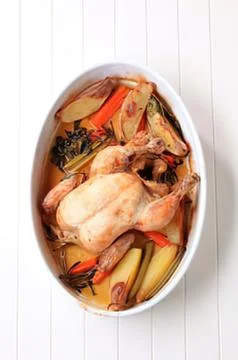 Roasted chicken with vegetables in a baking dish Stock Photos