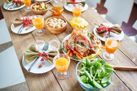 Roasted chicken with vegetables on holiday table Stock Photos