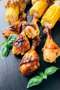 Roasted chicken's legs with corn Stock Photos