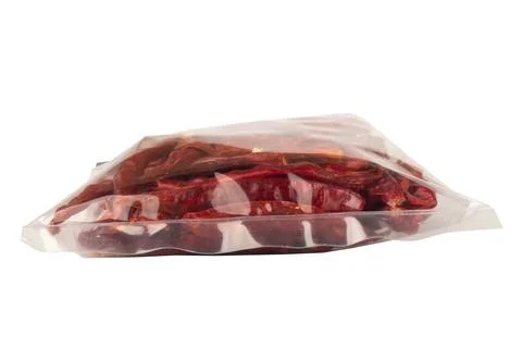 Roasted chilies in a plastic bag isolated on white background Фото