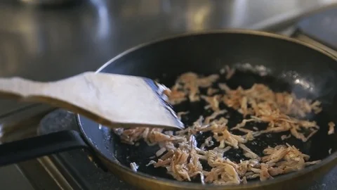 Roasted chopped bacon in a frying pan in slow motion Vídeo Stock 77480788