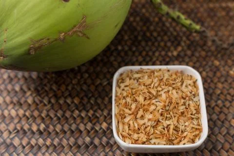 Roasted coconut in white cup. Stock Photos