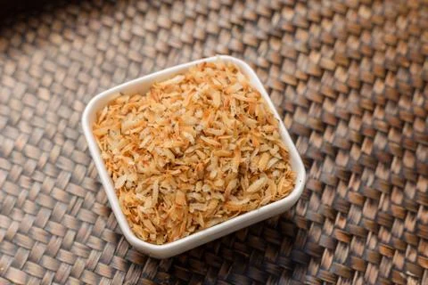 Roasted coconut in white cup. Stock Photos