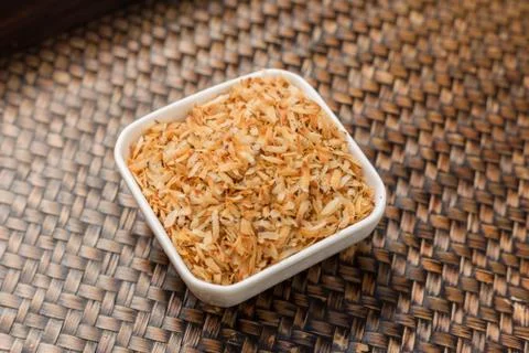 Roasted coconut in white cup. Stock Photos