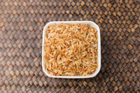 Roasted coconut in white cup. Stock Photos