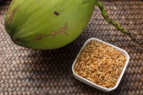 Roasted coconut in white cup. Stock Photos