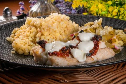 Roasted cod fish with bulgur. Stock Photos