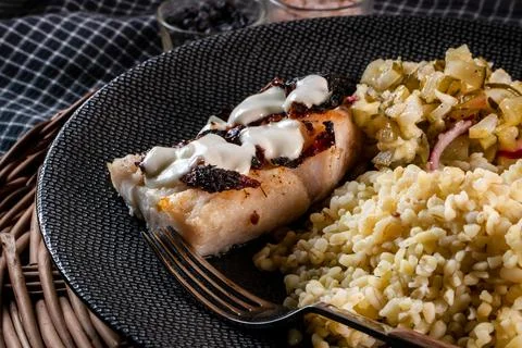 Roasted cod fish with bulgur. Stock Photos