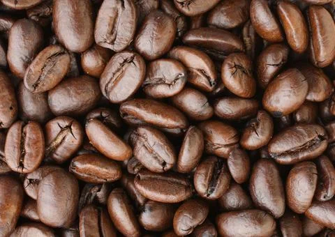 Roasted coffee bean background close-up Stock Photos