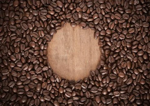 Roasted coffee bean background with a spherical space in the middle. Stock Photos