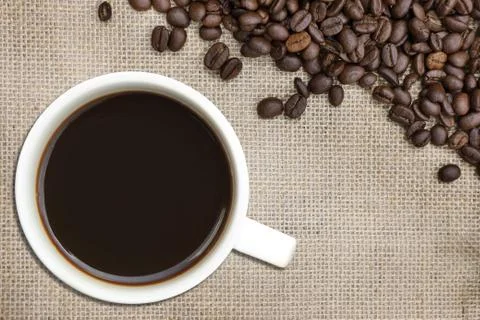 Roasted coffee bean on a  burlap sack Фото