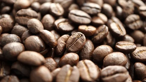 Roasted coffee bean fast spinning clockwise, selective focus Stock Footage 121109037