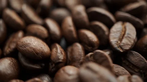 Roasted coffee bean rotating clockwise, focus changing to main subject Stock-Footage 121109008