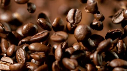 Roasted coffee beans after being exploded in super slow motion. Shooted with Stock Footage 94784104