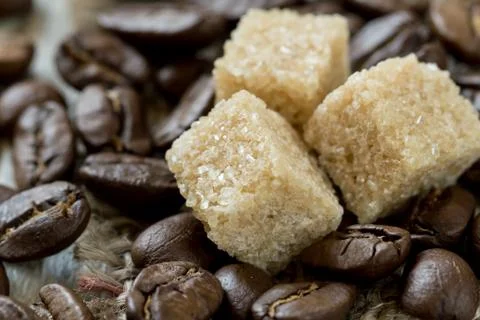 Roasted coffee beans and cane sugar close-up Stock Photos