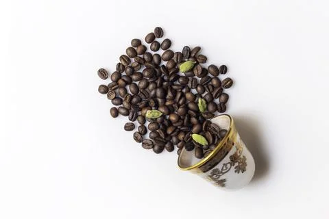 Roasted coffee beans and an empty coffee cup Stock Photos