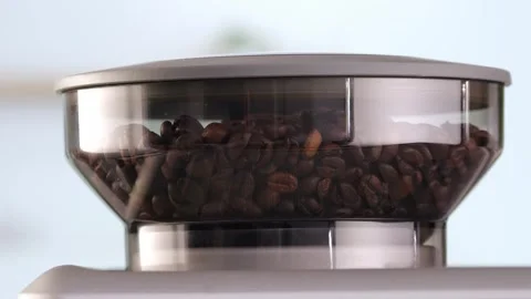 Roasted coffee beans are ground in a grinder of electric coffee machine. Drink a Stock Footage 256503286