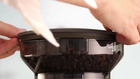 Roasted coffee beans are ground in a grinder of electric coffee machine. Drink a Stock Footage 256503505