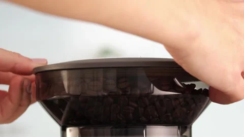 Roasted coffee beans are ground in a grinder of electric coffee machine. Drink a Stock Footage 259753826