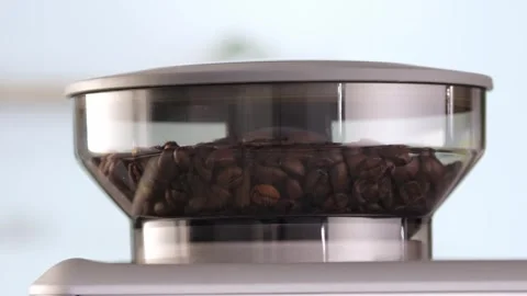 Roasted coffee beans are ground in a grinder of electric coffee machine. Drink a Stock Footage 270410486