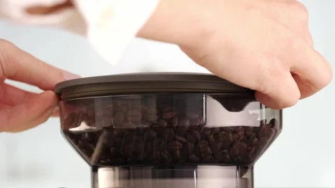 Roasted coffee beans are ground in a grinder of electric coffee machine. Drink a Stock Footage 274134480