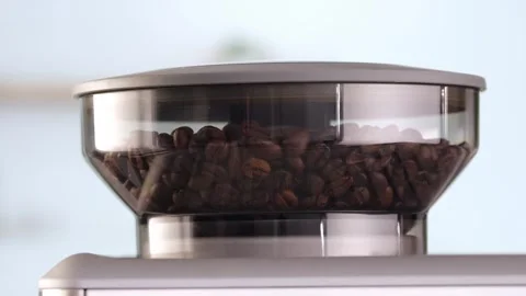 Roasted coffee beans are ground in a grinder of electric coffee machine. Drink a Stock Footage 276742497