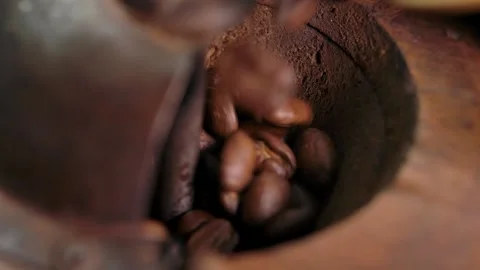 Roasted coffee beans are poured into an old manual coffee grinder Stock Footage 238478375
