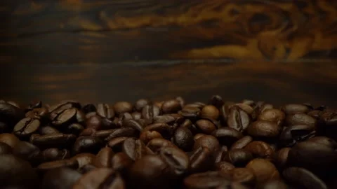 Roasted coffee beans are rotating in macro 4k video. Coffee beans close-up Stock Footage 151091641