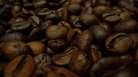 Roasted coffee beans are slowly rotating in macro 4k video. Coffee beans close 스톡 동영상 151091613
